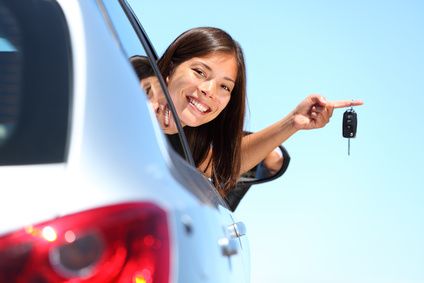 Driver holding up a new car key after car key replacement